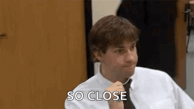 Man In White Shirt And Tie Talking At Table GIF
