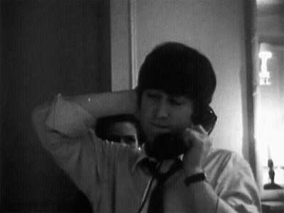 Man In White Shirt And Tie Talking On Phone GIF