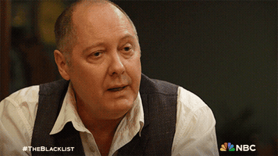 Man In White Shirt And Vest In Front Of NBC Logo GIF