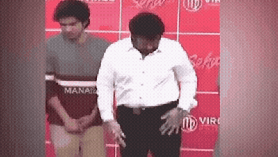 Man In White Shirt Before Red Wall Saying Manaso GIF