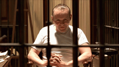Man In White Shirt Behind Bars GIF