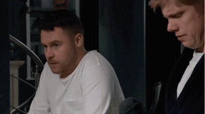 Man In White Shirt Beside Man In Black Robe GIF