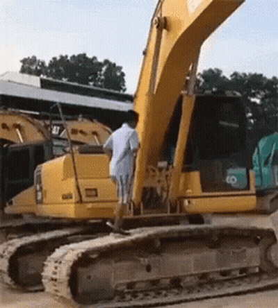 Man In White Shirt Beside Yellow Excavator Saying Cat GIF
