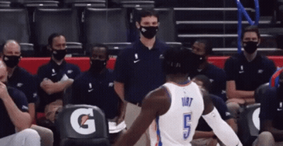 Man In White Shirt Blue Shorts Under Umbrella GIF
