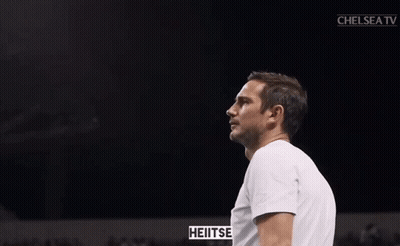 Man In White Shirt Clapping In Front Of Chelsea TV Screen GIF