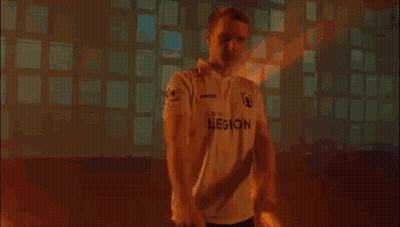 Man In White Shirt Covering Face In Dark Room GIF
