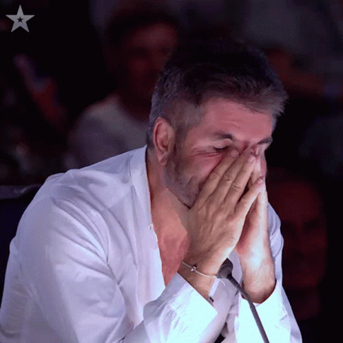 Man In White Shirt Covering Face With Hands Star In Background GIF