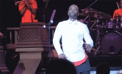 Man In White Shirt Dancing At Microphone GIF