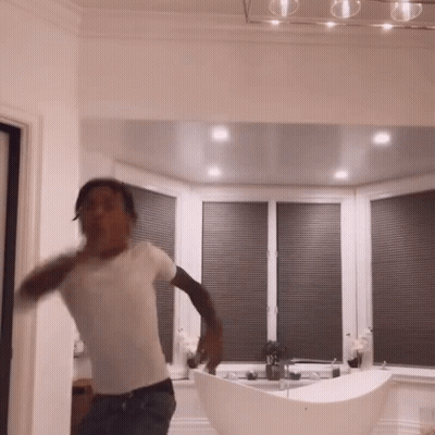 Man In White Shirt Dancing By Bathtub GIF