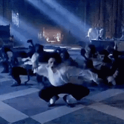 Man In White Shirt Dancing In Dark Room GIF