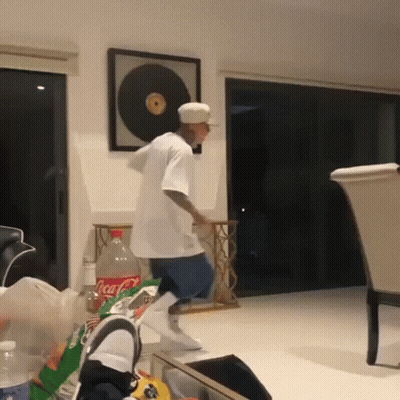 Man In White Shirt Dancing In Living Room With Coca Cola Bottle GIF