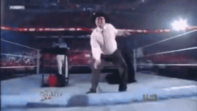 Man In White Shirt Dancing In Wrestling Ring GIF