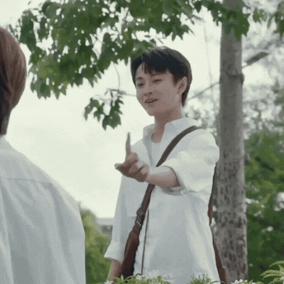 Man In White Shirt Giving Middle Finger With Brown Shoulder Bag GIF