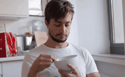 Man In White Shirt Holding Bowl Of Food GIF