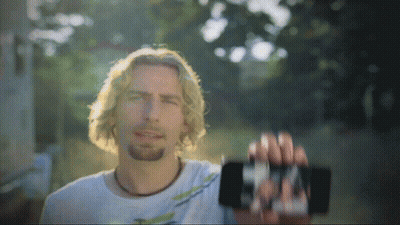 Man In White Shirt Holding Cell Phone GIF