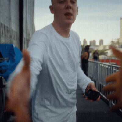 Man In White Shirt Holding Cell Phone GIF