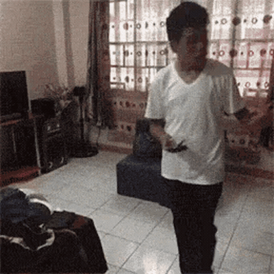 Man In White Shirt Holding Cell Phone GIF