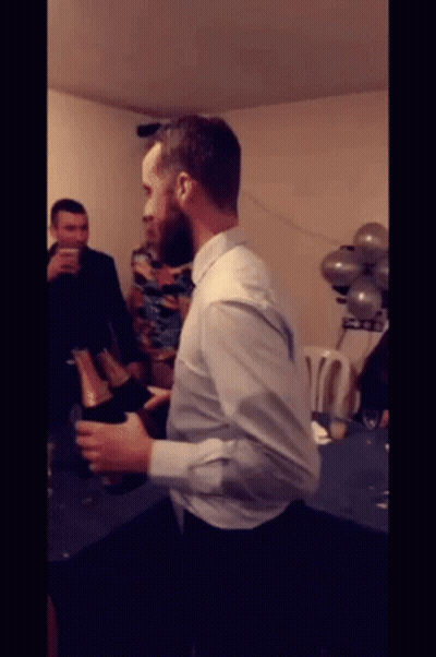 Man In White Shirt Holding Champagne GIF