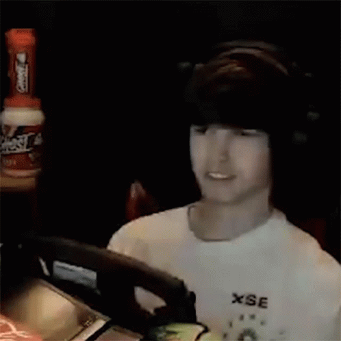 Man In White Shirt Holding Green Object GIF