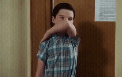 Man In White Shirt Holding Gun In Front Of Fence GIF