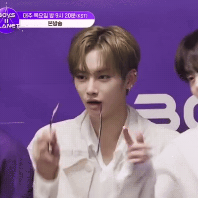 Man In White Shirt Holding Knife In Mouth And Pointing GIF