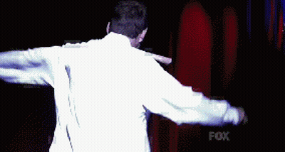 Man In White Shirt Holding Knife In Mouth In Front Of Fox GIF