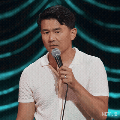 Man In White Shirt Holding Microphone With Netflix Logo GIF