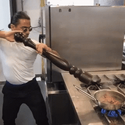 Man In White Shirt Holding Pepper Mill GIF