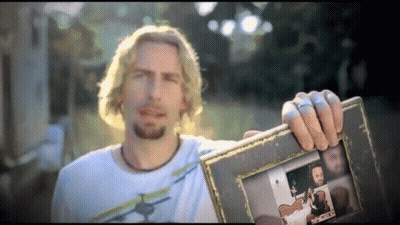 Man In White Shirt Holding Picture Frame GIF