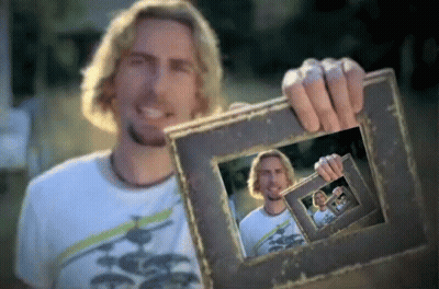 Man In White Shirt Holding Picture Frame Of Himself GIF