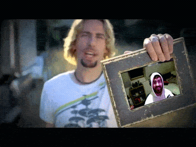 Man In White Shirt Holding Picture Of Man In Hoodie GIF