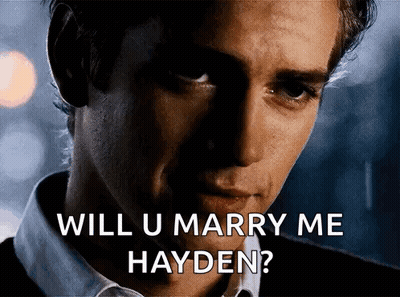 Man In White Shirt Holding Pink Container With Hayden Mi Amor GIF