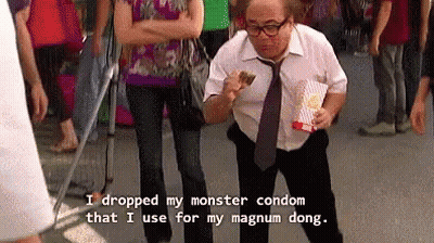 Man In White Shirt Holding Popcorn And Condom GIF