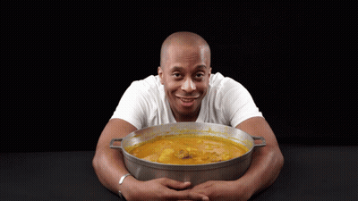 Man In White Shirt Holding Pot Of Soup GIF
