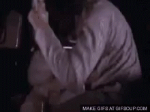 Man In White Shirt Holding Something GIF