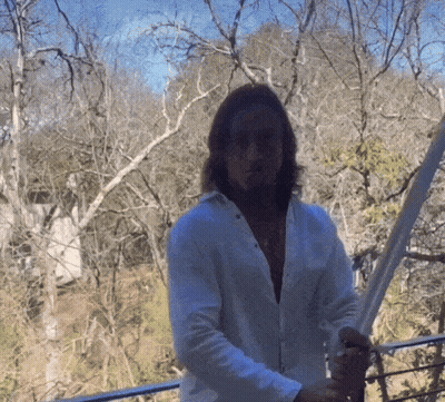 Man In White Shirt Holding Sword In Forest GIF