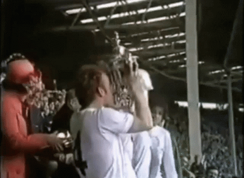 Man In White Shirt Holding Trophy GIF