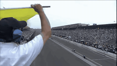 Man In White Shirt Holding Yellow Flag GIF
