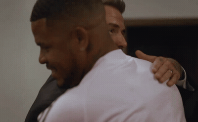 Man In White Shirt Hugging Man In Black Suit GIF