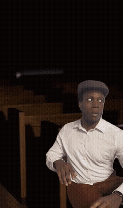 Man In White Shirt In Church With Altar Candles GIF