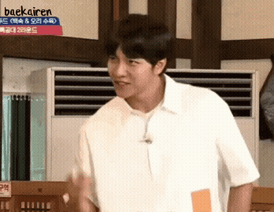 Man In White Shirt In Front Of Baekairen Sign GIF