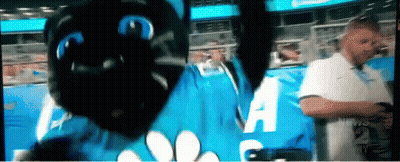 Man In White Shirt In Front Of Blue Sign Saying A GIF