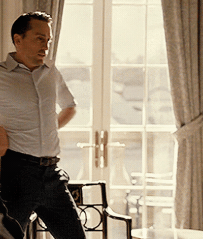 Man In White Shirt In Front Of Large Window GIF
