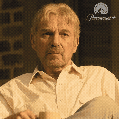 Man In White Shirt In Front Of Paramount Sign GIF