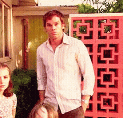 Man In White Shirt In Front Of Pink Wall With Squares GIF