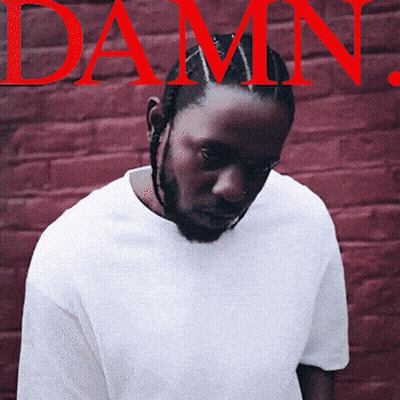 Man In White Shirt In Front Of Red Brick Wall Damn GIF