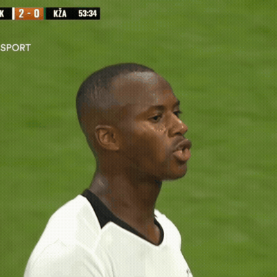 Man In White Shirt In Front Of Scoreboard Saying K 2-0 Kza GIF