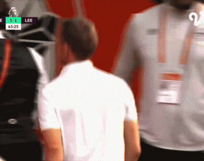 Man In White Shirt In Front Of Screen Saying Lee GIF