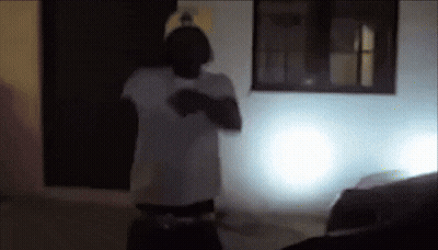 Man In White Shirt In Front Of White Building GIF