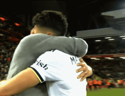 Man In White Shirt Irish Hugging Another GIF
